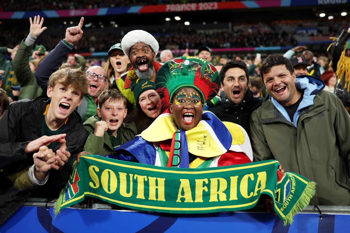 Springbok fans cheering at the stadium barrier before kick-off