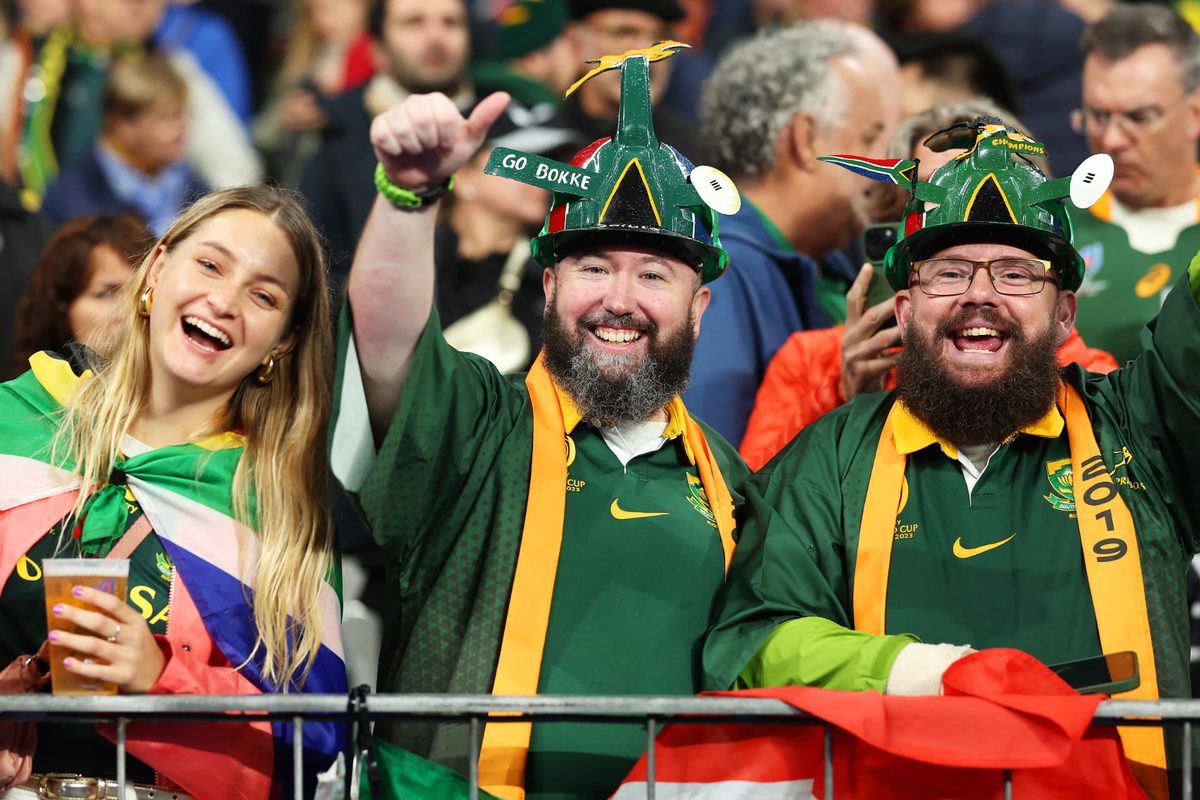 Springbok fans in supporter hats and jerseys enjoying match day